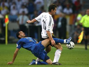 (R-L) Germany's Miroslav Klose is challenged by Italy's Gianluca Zambrotta.